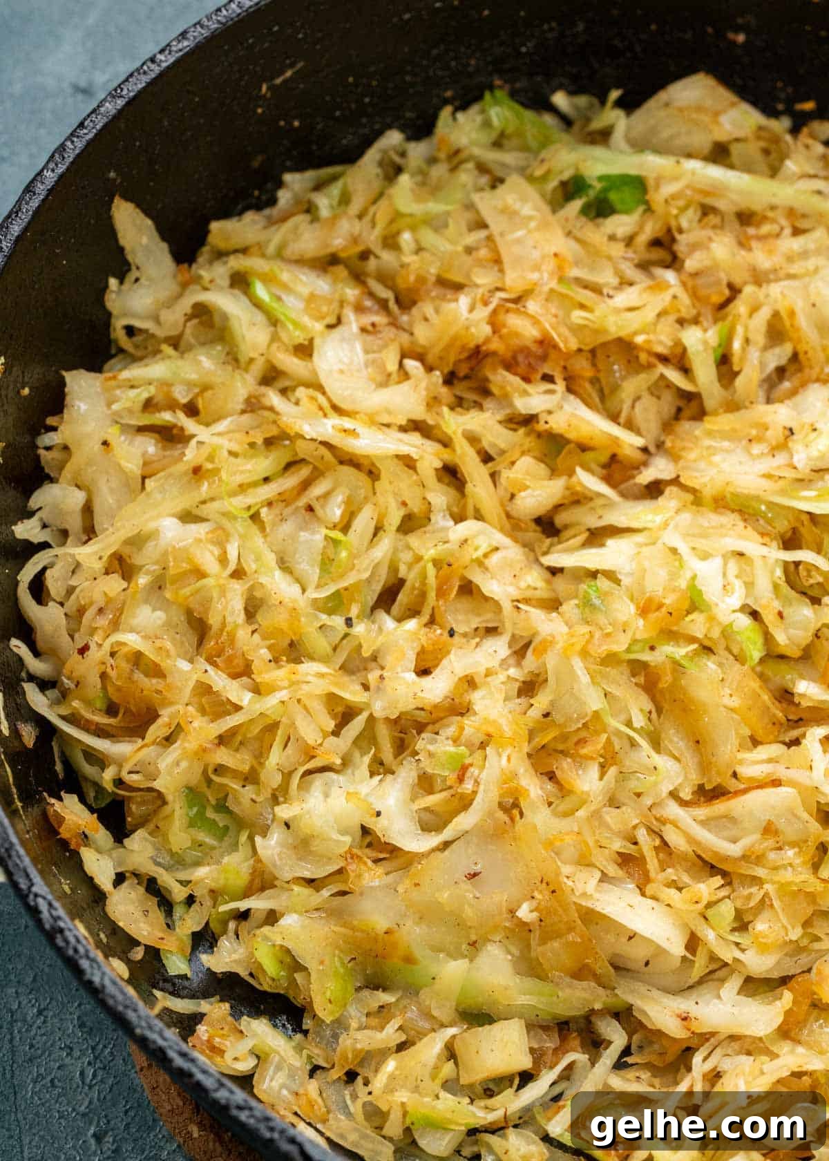 fried cabbage with softened onions in a pan