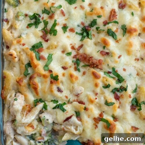 This baked Chicken Broccoli Alfredo Pasta is a hearty upgrade on your favorite fettuccini Alfredo recipe. Made with shredded chicken, crispy bacon, broccoli, homemade Alfredo sauce and tons of cheese, this cheesy chicken Alfredo casserole is an ultimate comfort food favorite!