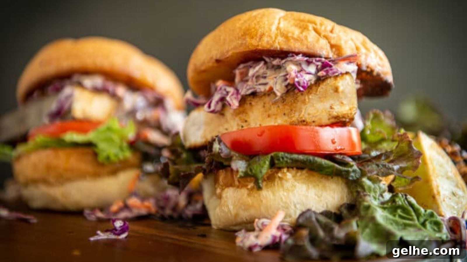 Swordfish blackened and layered into a sandwich with slaw on toasted bread.