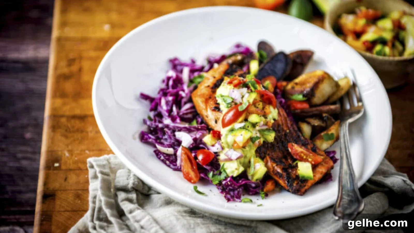 Salmon blackened in cast iron with dark charred crust and flaky interior.