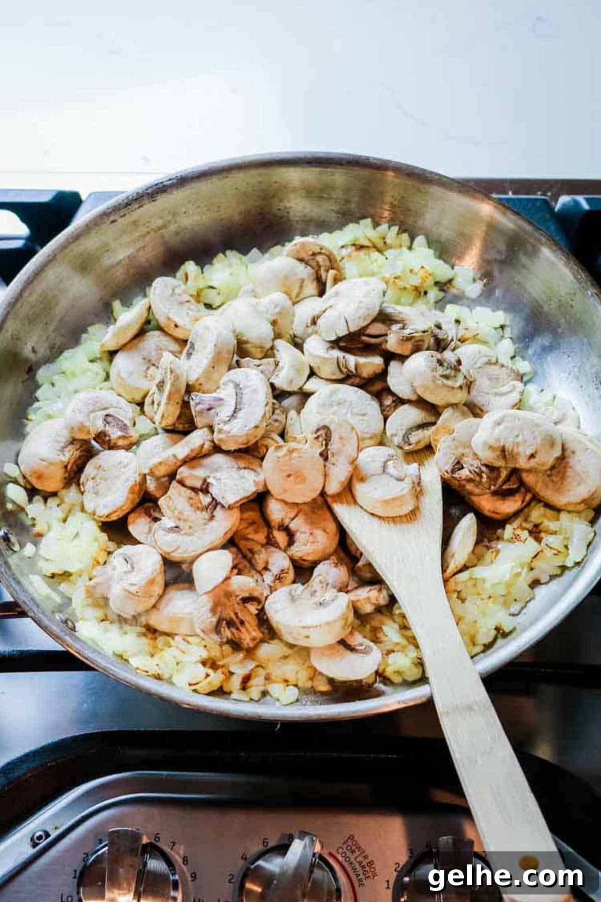 onions and mushrooms sauteed in stainless steel skillet.