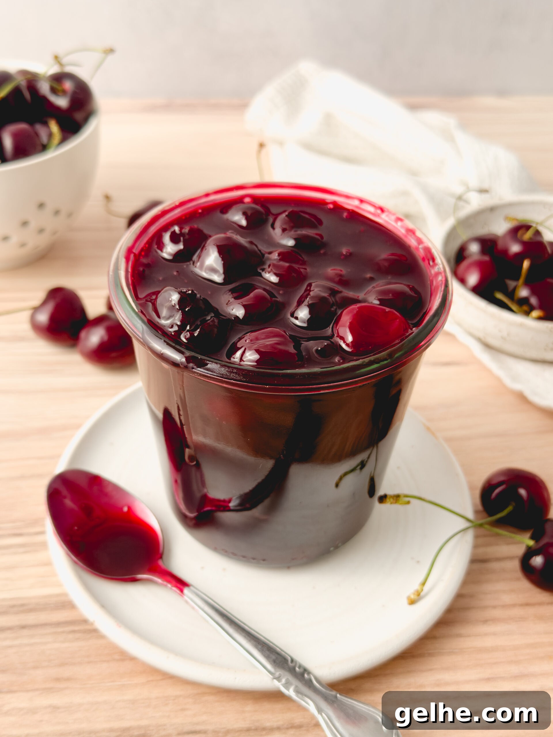 Cherry compote in bowl with spoon