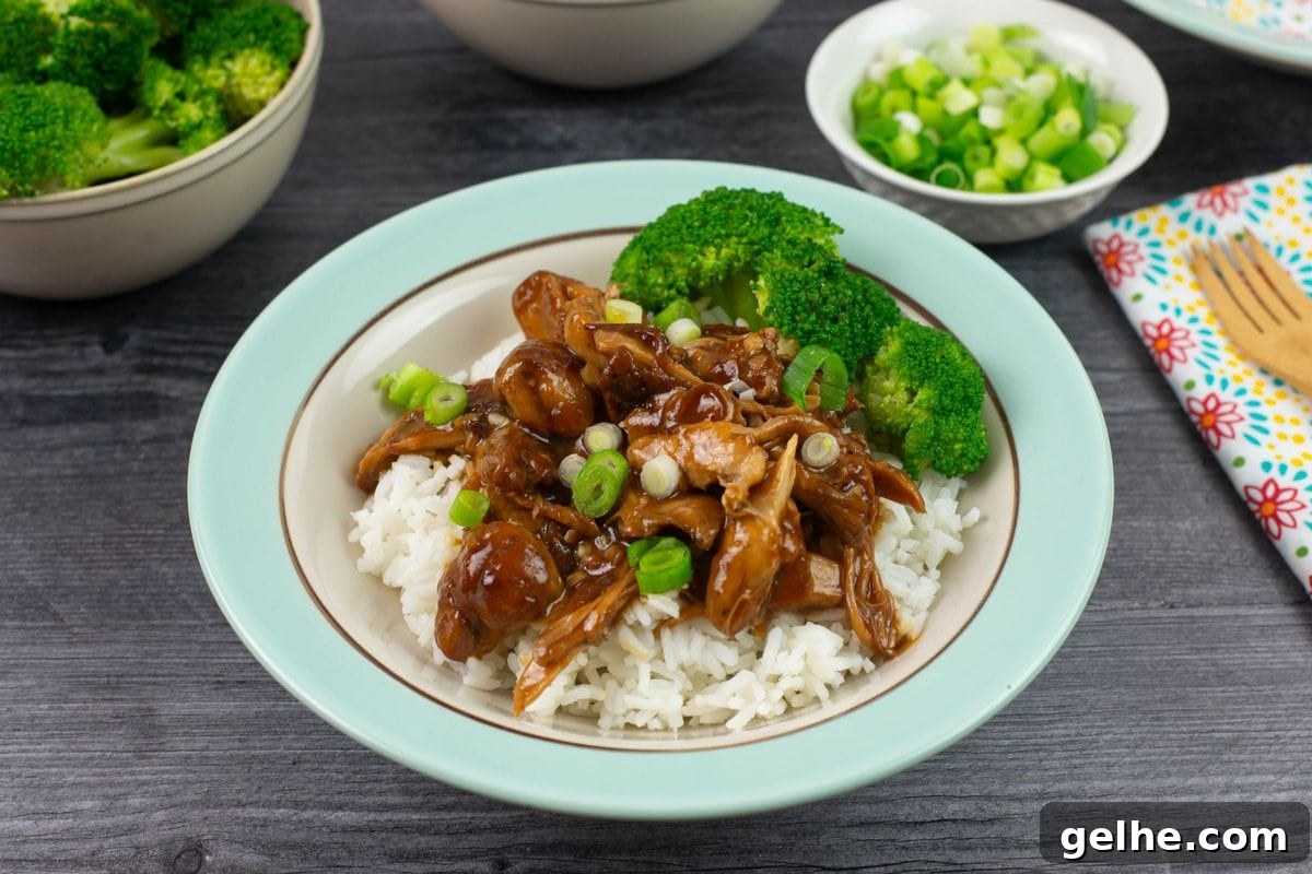 Garnished dish with green onion and served with steamed broccoli.