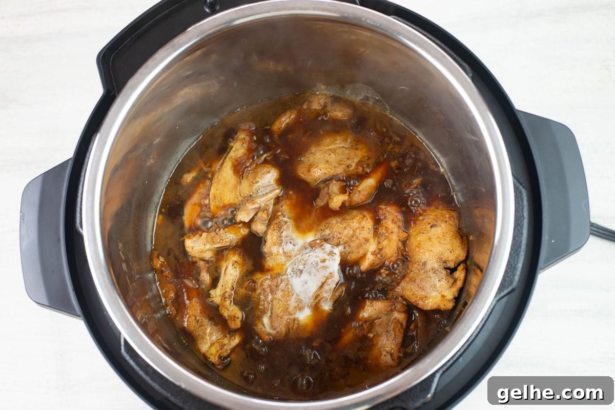 Adding corn starch slurry to the sauce to thicken.