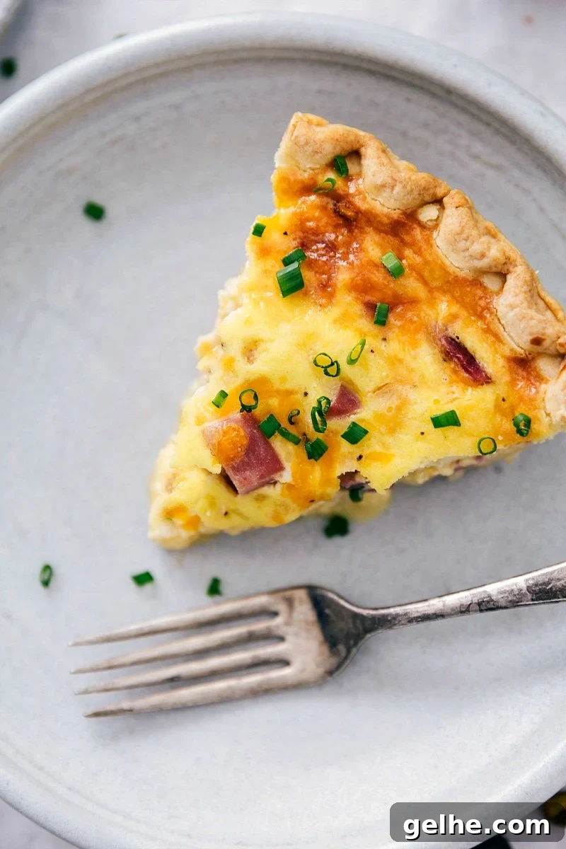 Slice of scrumptious ham and cheese quiche.