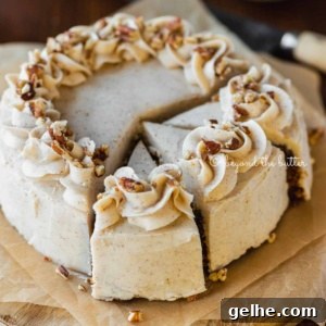 Moist One-Layer Carrot Cake Recipe for Any Occasion 8 Angled overhead image of sliced 6 inch single layer carrot cake on parchment paper with bowls of nuts, frosting, and a knife in the background on wood table.