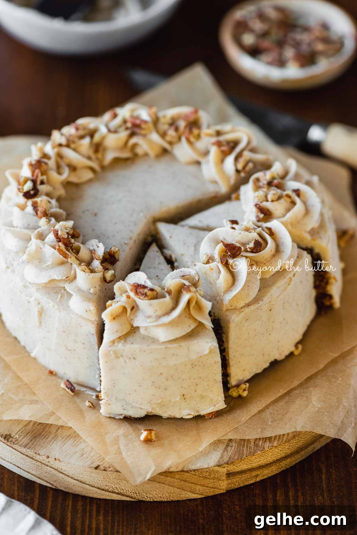 Moist One-Layer Carrot Cake Recipe for Any Occasion 4 Angled overhead image of sliced 6 inch single layer carrot cake on parchment paper | All Images © Beyond the Butter®