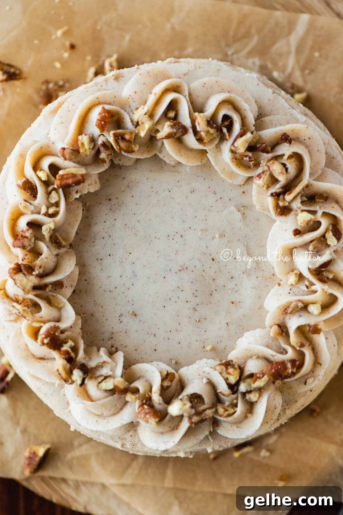 Moist One-Layer Carrot Cake Recipe for Any Occasion 5 Overhead closeup image of 6 inch carrot cake frosted on sheets of brown parchment paper | All Images © Beyond the Butter®