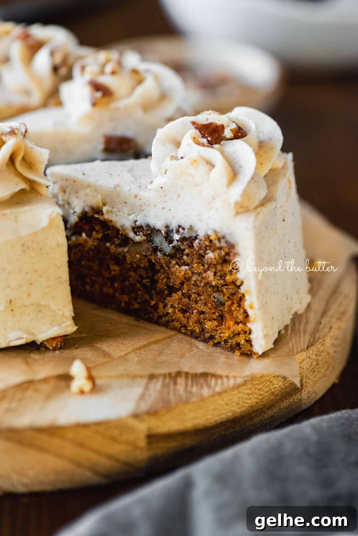 Moist One-Layer Carrot Cake Recipe for Any Occasion 6 Angled closeup image of sliced 6 inch single layer carrot cake on parchment paper | All Images © Beyond the Butter®