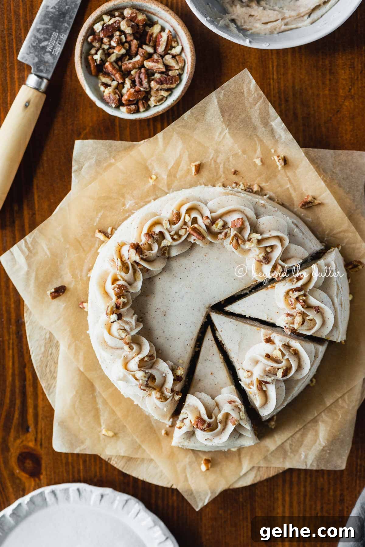Moist One-Layer Carrot Cake Recipe for Any Occasion 7 Overhead image of sliced 6 inch single layer carrot cake on parchment paper | All Images © Beyond the Butter®