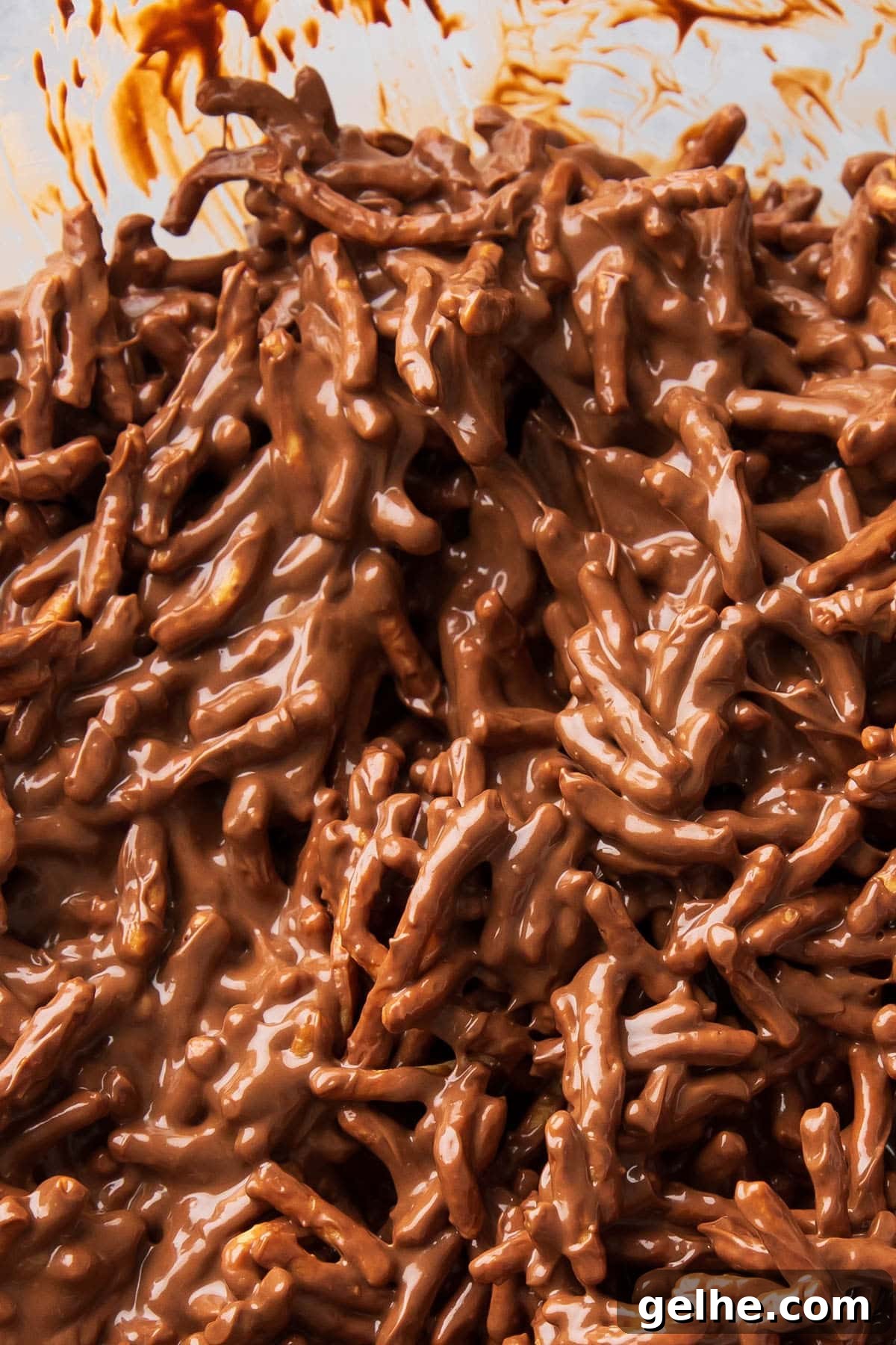 Melted chocolate, butterscotch, and peanut butter coating chow mein noodles to make this unbaked mixture.