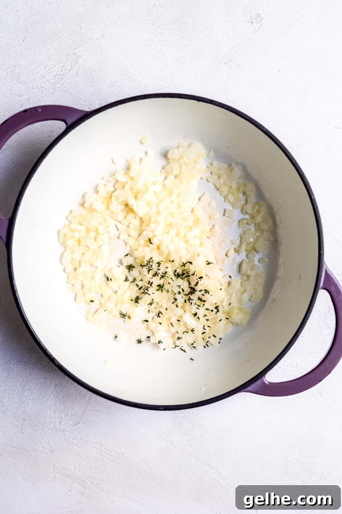 Melting butter and adding onion into the pan for pilau rice.