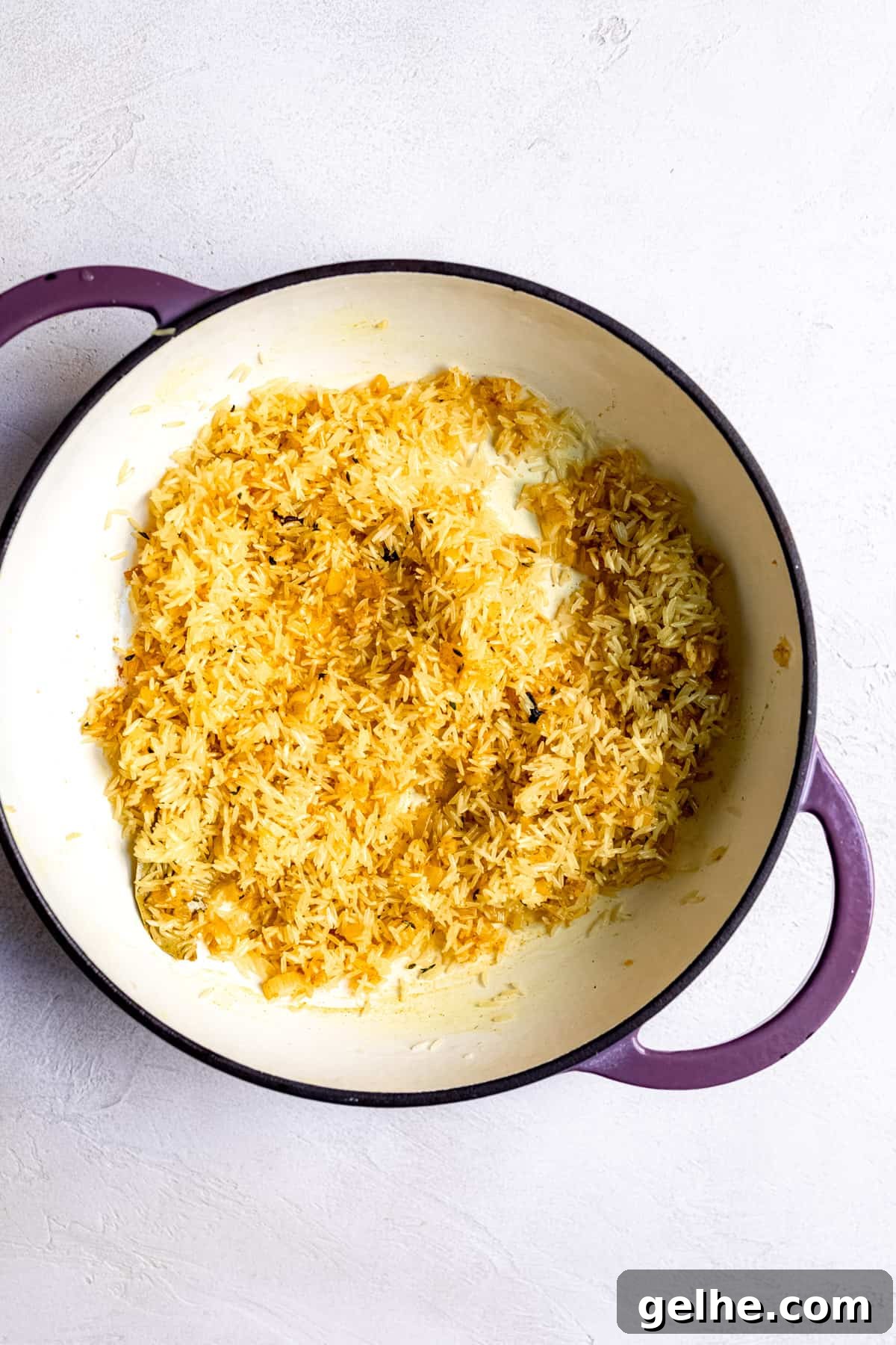 Basmati rice being mixed with the spices for pilau rice.