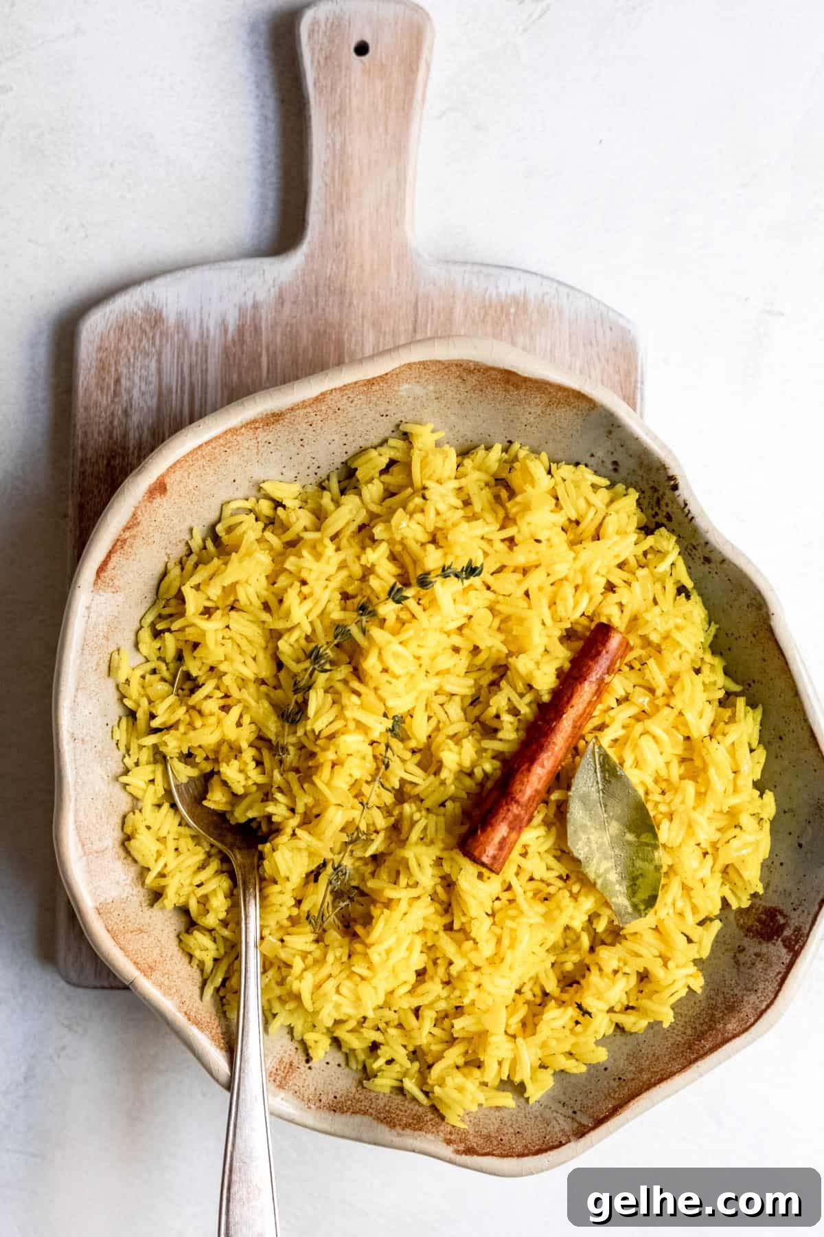 Cooked pilau rice with a bay leaf and seasoning.