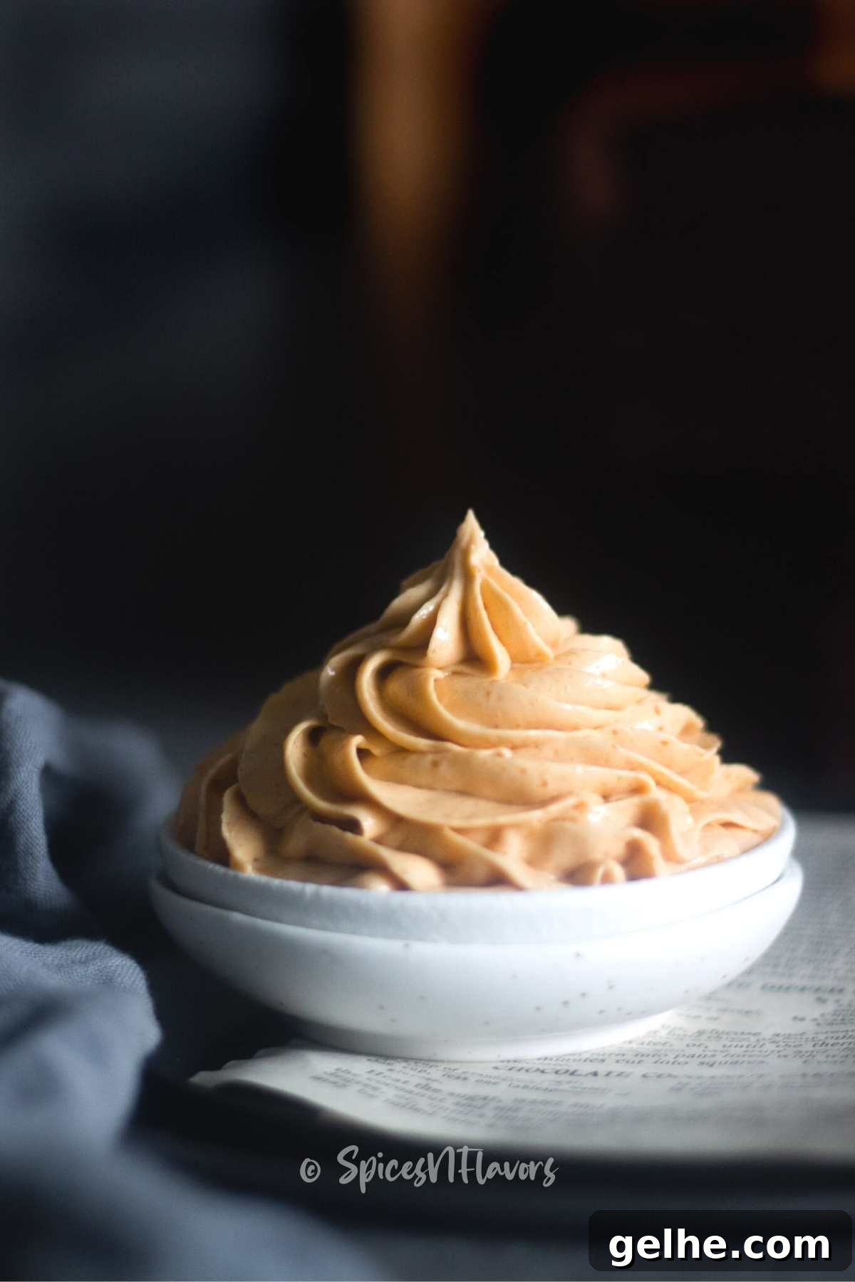 swirl of peanut butter cream cheese frosting piped on a small white bowl