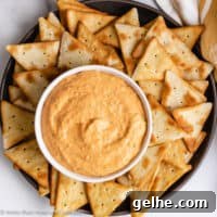 Top down view of roasted red pepper dip on a serving plate.