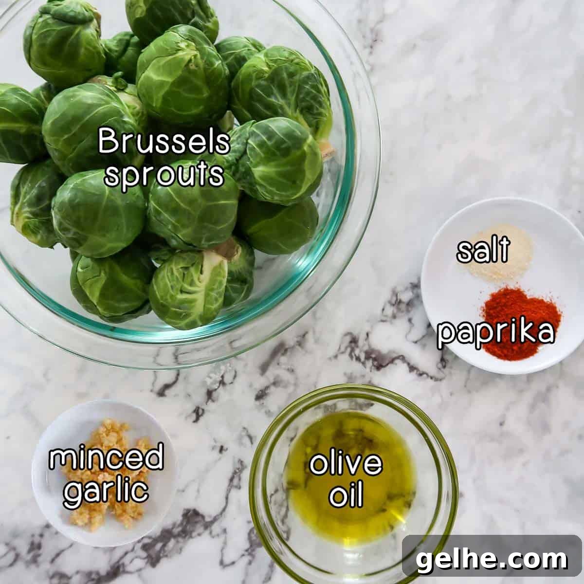 Overhead shot of ingredients- brussel sprouts, minced garlic, olive oil, salt, and paprika.