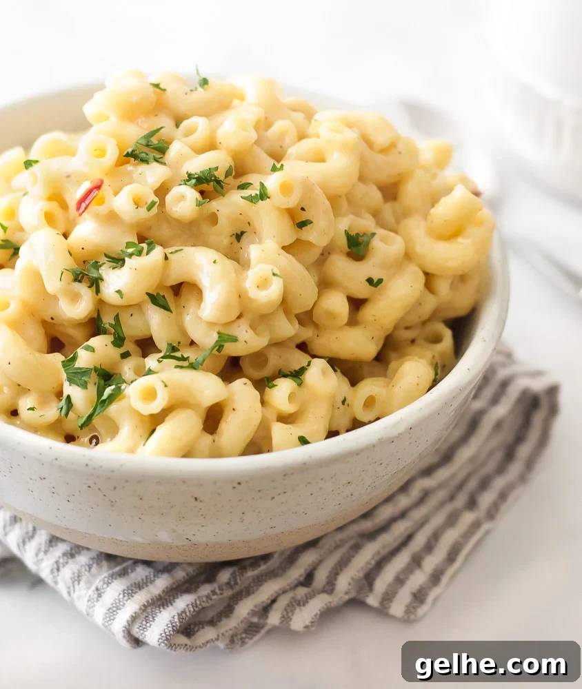 A bowl of creamy stovetop mac and cheese that's cheddar cheese based. Cheesy but not heavy or gloppy.