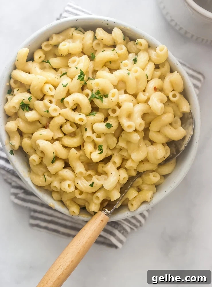 A bowl of creamy stovetop mac and cheese that's cheddar cheese based. Cheesy but not heavy or gloppy.