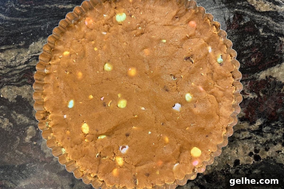 Gluten-Free Peanut Butter Cookie Cake Recipe for Dense, Chewy Slices 5 Peanut butter cookie dough in a 9 inch round tart pan.