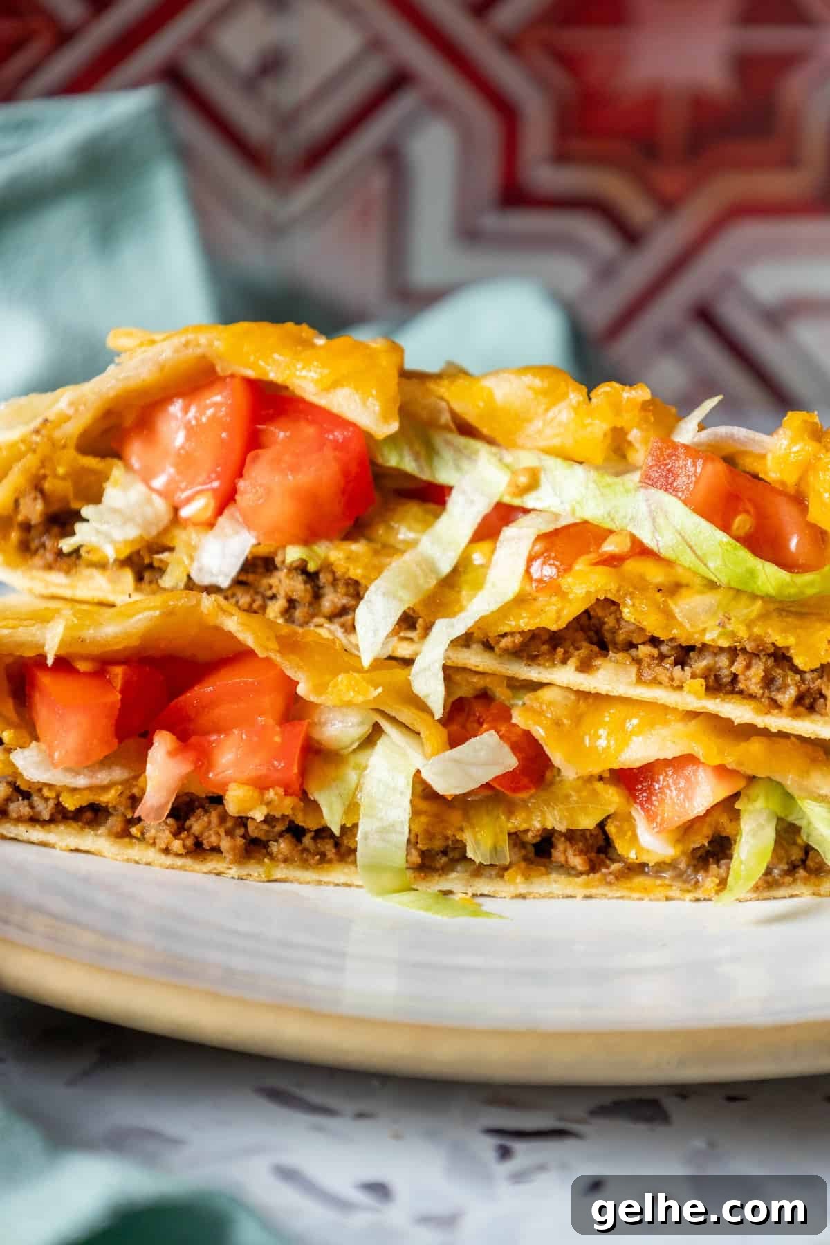 Crispy Homemade Crunchwrap Recipe: Copycat Taco Bell Wrap 12 Two homemade quesadillas are stacked on a plate.