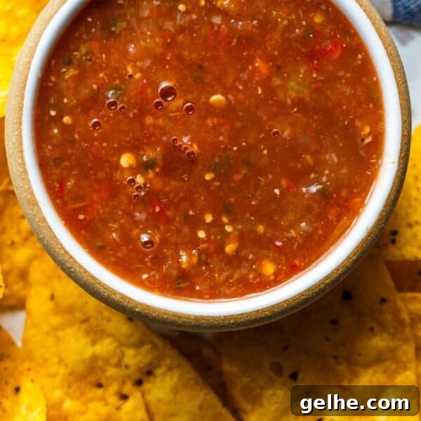 Crispy Homemade Crunchwrap Recipe: Copycat Taco Bell Wrap 17 A bowl of chunky roasted salsa surrounded by yellow corn tortilla chips.