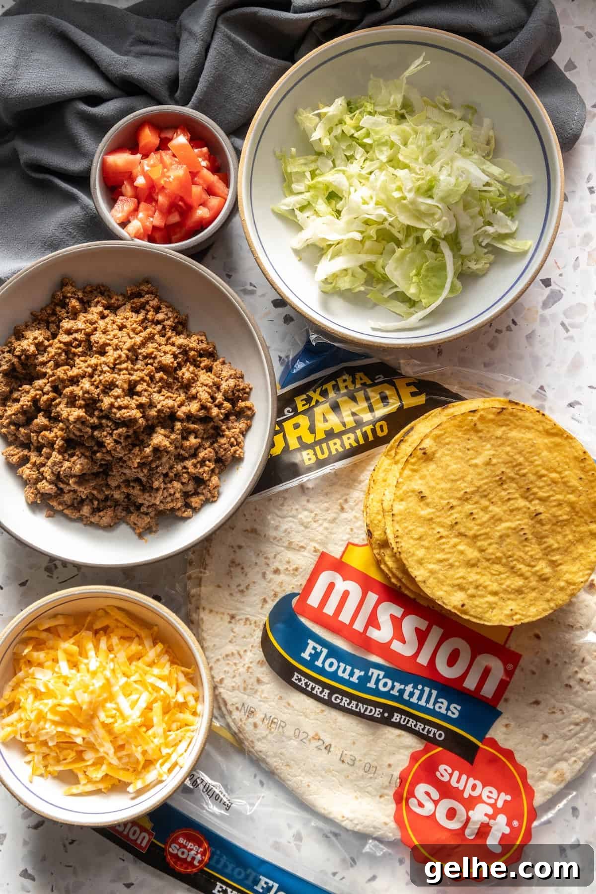 Crispy Homemade Crunchwrap Recipe: Copycat Taco Bell Wrap 5 Ingredients for a homemade Mission Texas burrito laid out on a table.