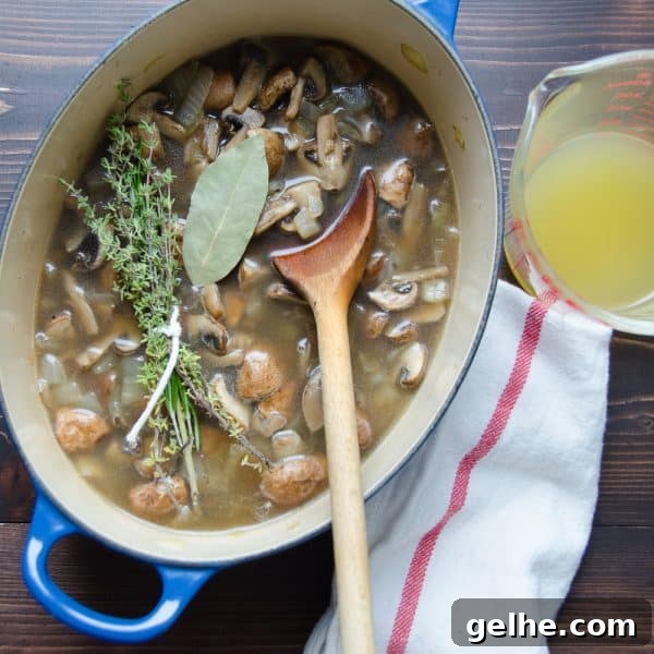 Silky Mushroom Bisque Recipe 5 mushrooms broth and herbs with spoon