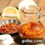 a container with a popular hot sauce in Sudan called shata it has hot chili flakes, garlic and lemons.