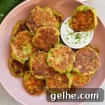 Zucchini and edamame fritters dipped in yoghurt sauce.