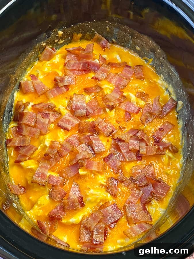 Thick layer of cheese and bacon on cheesy ranch and cream cheese chicken
