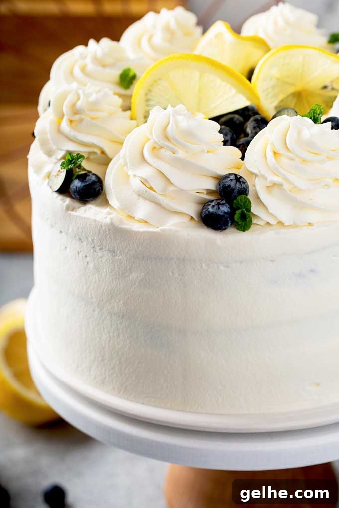 Close up view of lemon cake with whipped mascarpone frosting on a cake platter