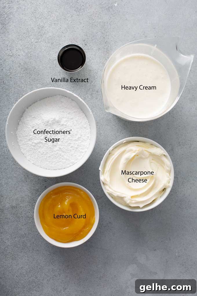 Ingredients to make whipped mascarpone frosting on a gray surface