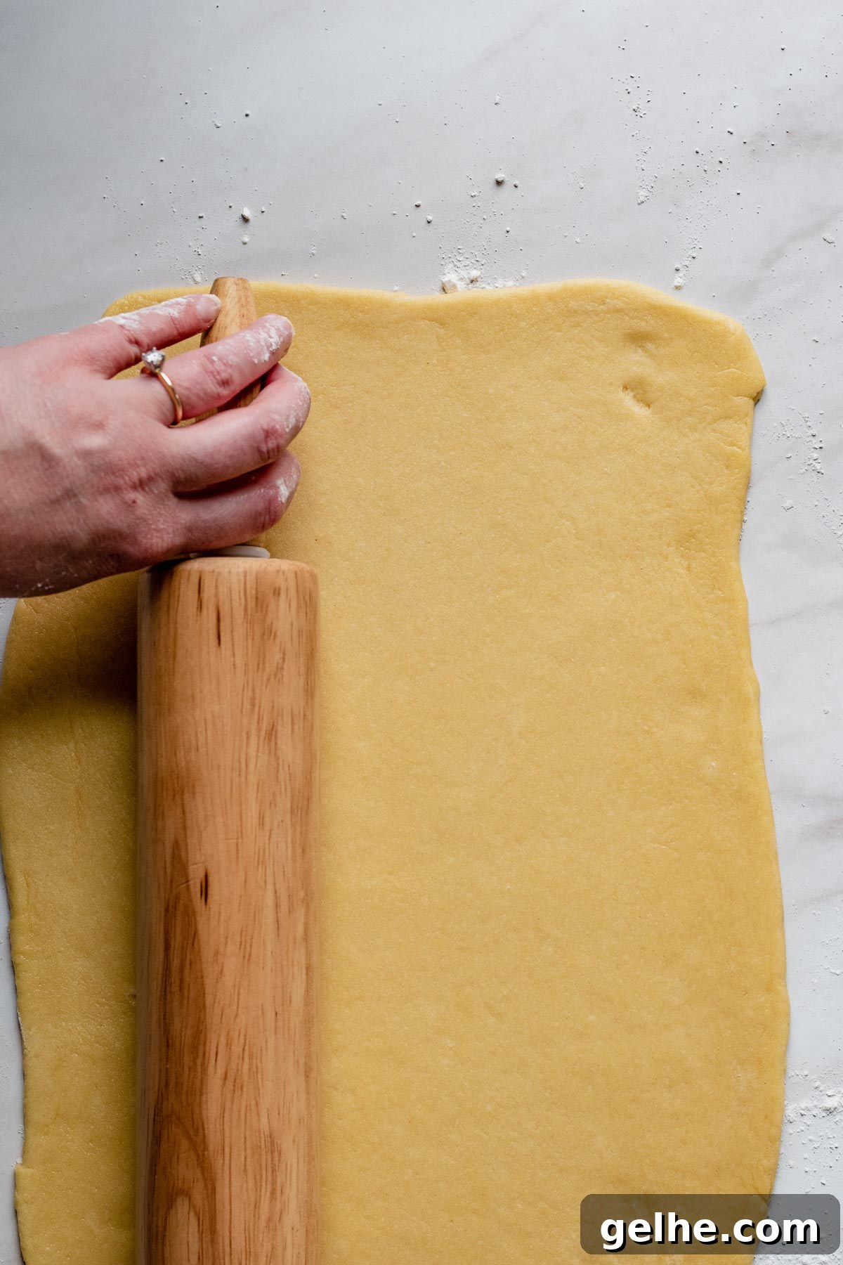 Rolling pin rolls out the dough.
