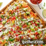 A sheet pan of loaded steak nachos.
