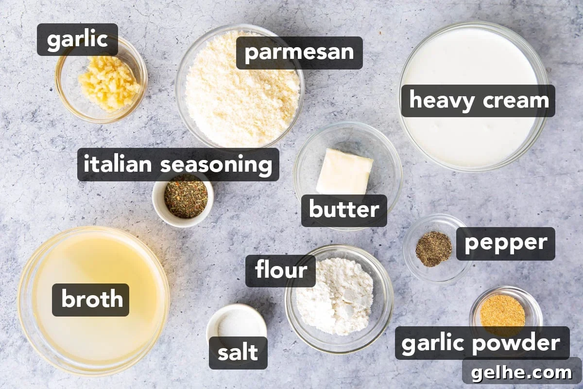 Homemade Creamy Garlic Parmesan Sauce 3 Garlic parmesan sauce ingredients in prep bowls, including parmesan, heavy cream, butter, chicken broth, Italian seasoning, black pepper, salt, minced garlic, and garlic powder.