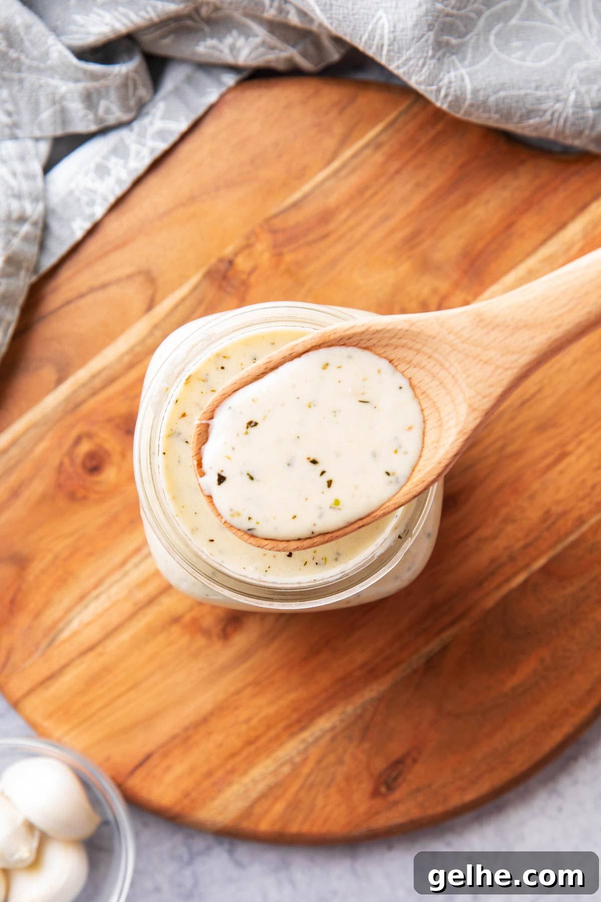 Homemade Creamy Garlic Parmesan Sauce 6 Spooning this wing, pizza, and pasta pairing into a glass jar.