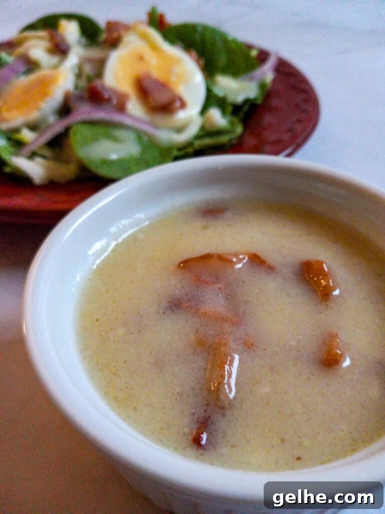 small bowl of dressing and a plate of salad