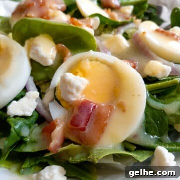 bowl of salad topped with bacon dressing